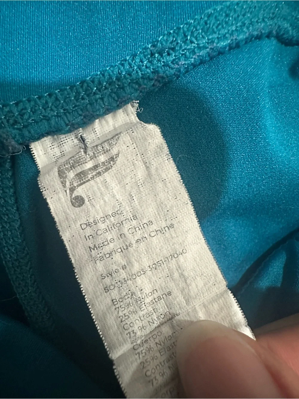 Fabletics Trinity Mid Rise Pocket Biker Shorts in Azure/Green Mist $59.95